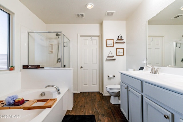 full bathroom with toilet, vanity, shower with separate bathtub, and hardwood / wood-style flooring