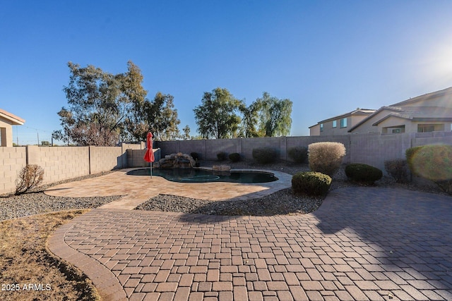 view of patio featuring a fenced in pool