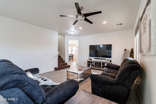 living room with ceiling fan and light hardwood / wood-style floors