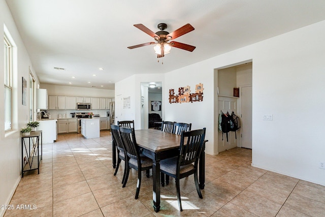 dining area featuring ceiling fan and light tile patterned floors