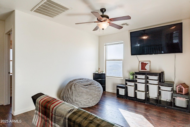 living area featuring ceiling fan and dark hardwood / wood-style floors