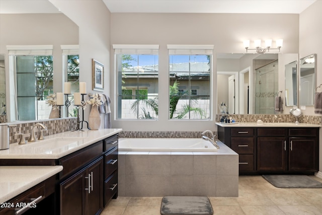 bathroom with independent shower and bath, vanity, tile patterned floors, and backsplash