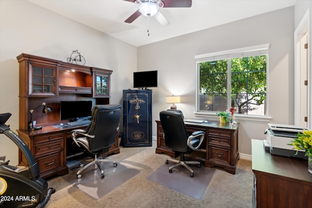 carpeted home office featuring ceiling fan