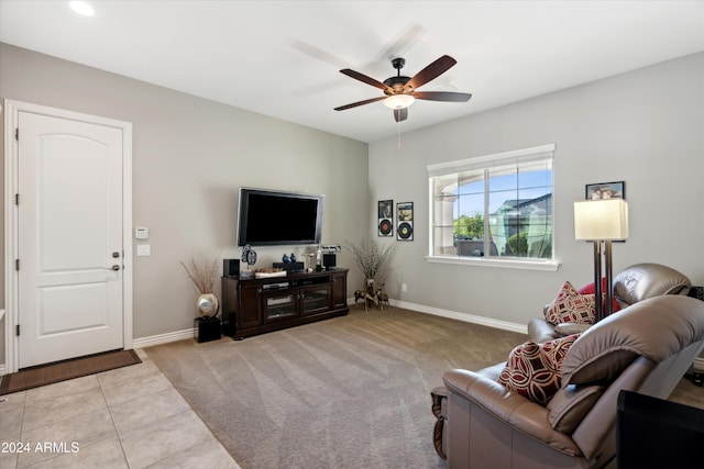 living room featuring light colored carpet and ceiling fan