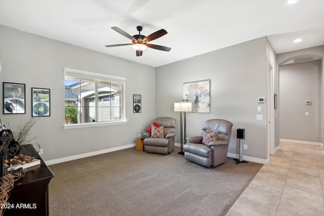 living area featuring ceiling fan and light carpet