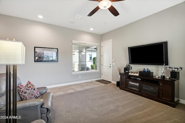 living room featuring light colored carpet and ceiling fan