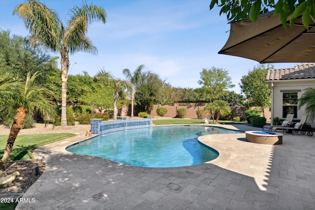 view of pool with pool water feature, a patio, and a fire pit