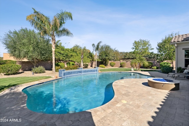 view of pool with a patio and a fire pit