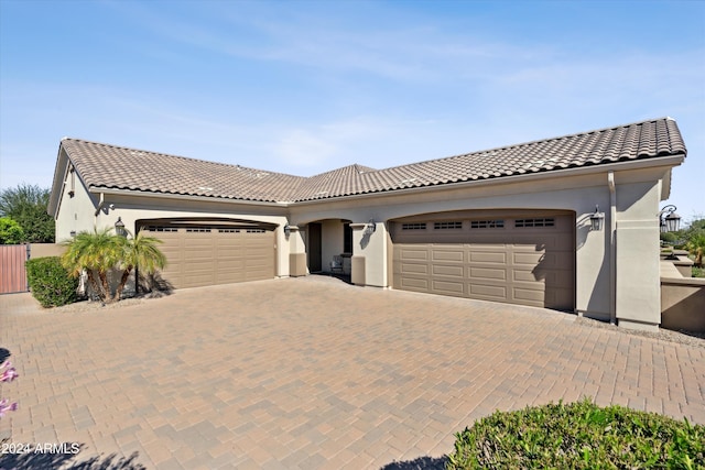 mediterranean / spanish-style house featuring a garage