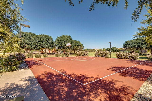 view of tennis court featuring basketball hoop