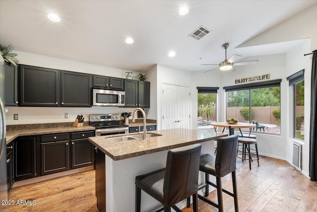 7471 E Desert Vista Rd, Scottsdale, AZ 85255 - kitchen featuring a sink, light wood-type flooring, ceiling fan, and appliances with stainless steel finishes