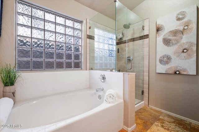 7471 E Desert Vista Rd, Scottsdale, AZ 85255 - full bathroom featuring baseboards, a garden tub, a shower stall, and stone finish flooring