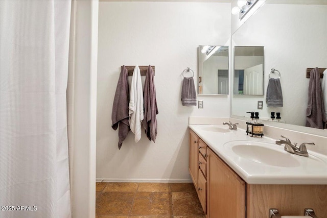 7471 E Desert Vista Rd, Scottsdale, AZ 85255 - full bath with double vanity, a sink, curtained shower, and baseboards