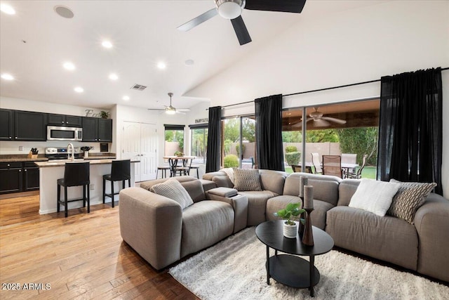 7471 E Desert Vista Rd, Scottsdale, AZ 85255 - living area with high vaulted ceiling, light wood-style flooring, visible vents, ceiling fan, and recessed lighting