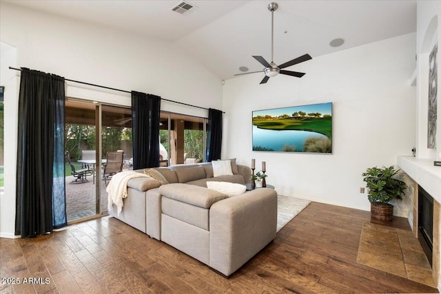 7471 E Desert Vista Rd, Scottsdale, AZ 85255 - living area with high vaulted ceiling, ceiling fan, visible vents, a fireplace, and wood finished floors
