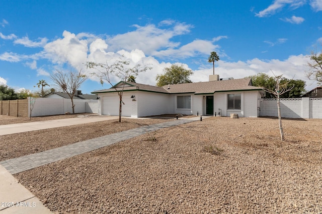 ranch-style home featuring a garage