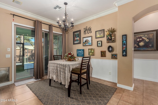 tiled dining space with a chandelier and ornamental molding