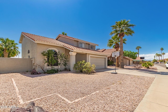 mediterranean / spanish-style house featuring fence, a tile roof, stucco siding, driveway, and an attached garage