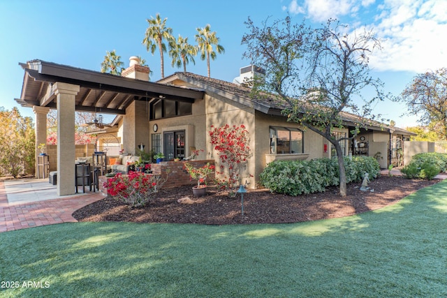 view of property exterior featuring a yard and a patio area