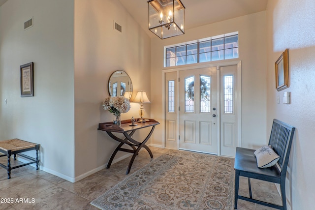 foyer featuring a high ceiling and a notable chandelier