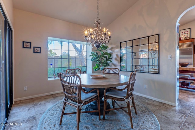 dining area with lofted ceiling and a notable chandelier