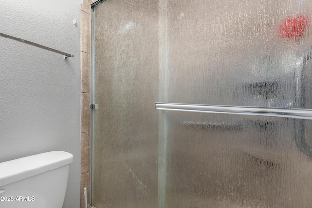 711 E Laurel Dr Unit 17, Casa Grande, AZ 85122 - full bath featuring elevator, toilet, a textured wall, and a stall shower