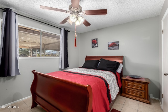 711 E Laurel Dr Unit 17, Casa Grande, AZ 85122 - bedroom with tile patterned floors, baseboards, a textured ceiling, and a ceiling fan