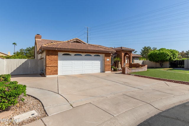 view of front of home featuring a garage and a front lawn