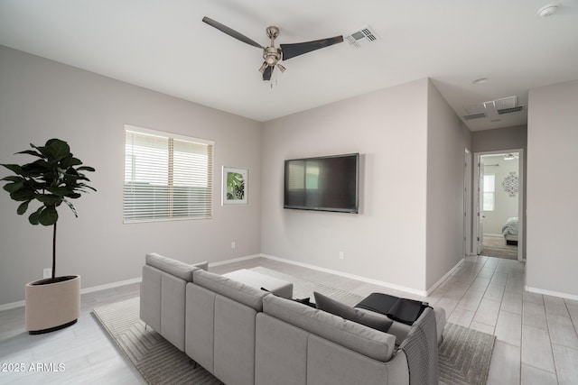 living room with light wood-type flooring and ceiling fan