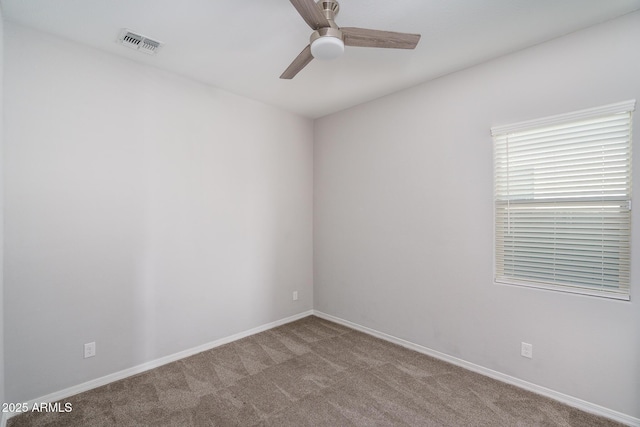 carpeted spare room featuring ceiling fan