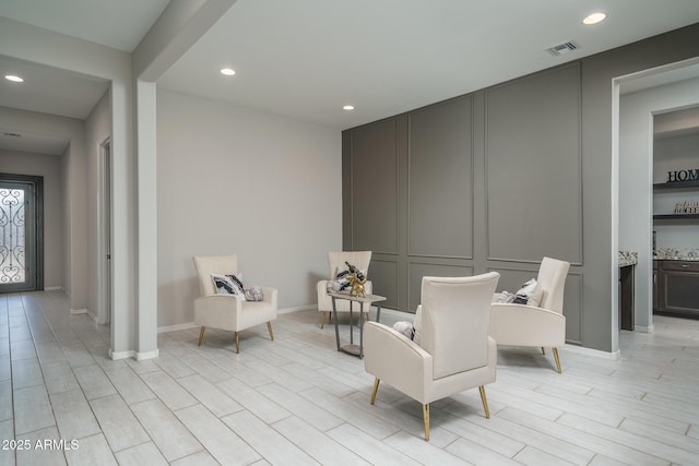 sitting room featuring light hardwood / wood-style flooring