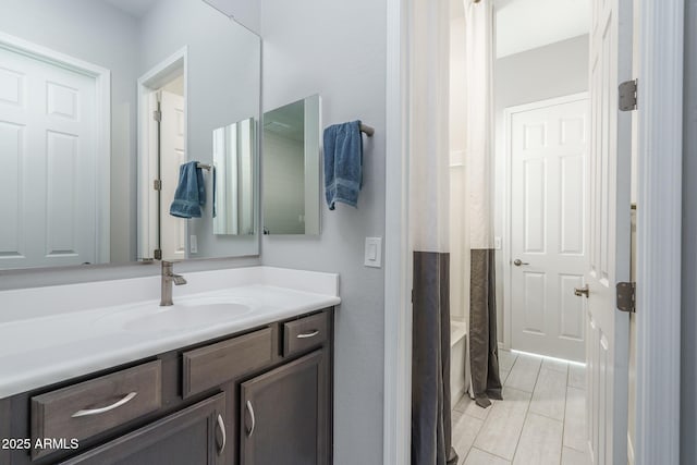 bathroom featuring vanity and  shower combination