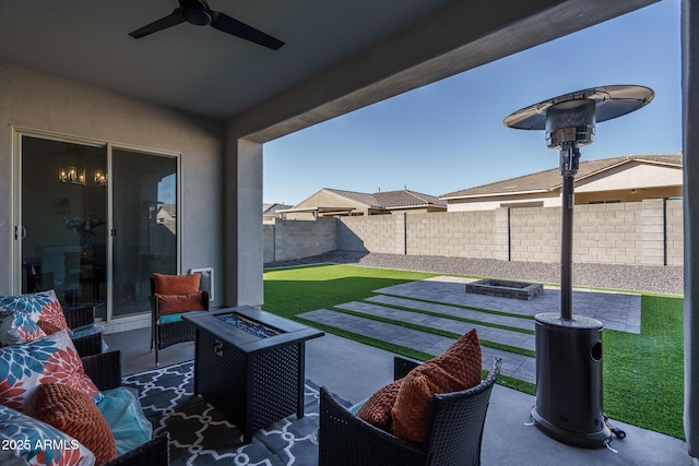 view of patio with ceiling fan and an outdoor fire pit