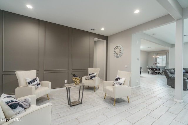 sitting room featuring an inviting chandelier