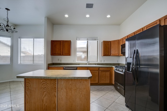 kitchen featuring black appliances, light tile patterned floors, visible vents, and a sink