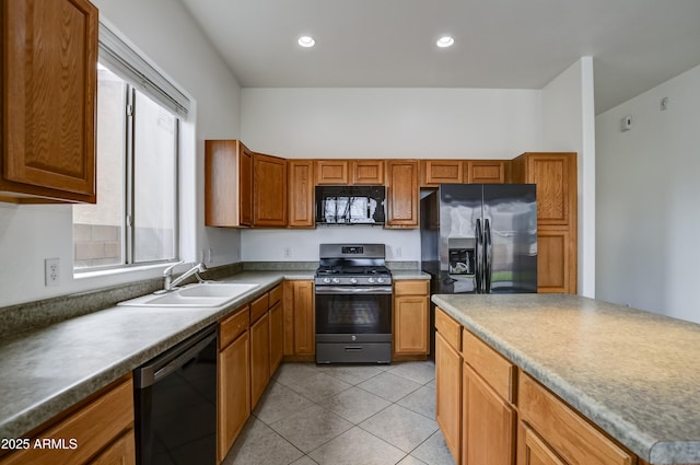 kitchen with light tile patterned floors, recessed lighting, brown cabinets, black appliances, and a sink