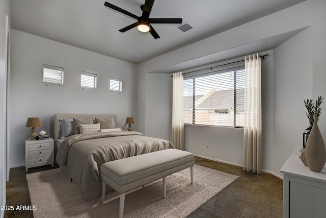 bedroom with visible vents, ceiling fan, baseboards, and dark colored carpet