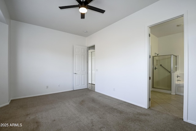 spare room featuring carpet flooring, a ceiling fan, and baseboards