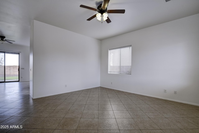 spare room featuring tile patterned floors, baseboards, and a ceiling fan