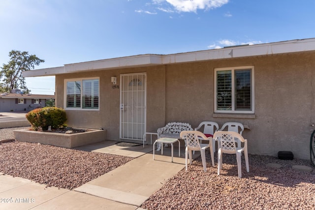 property entrance featuring a patio