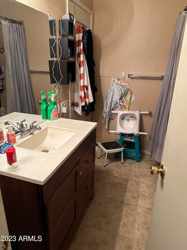 bathroom with tile floors and vanity