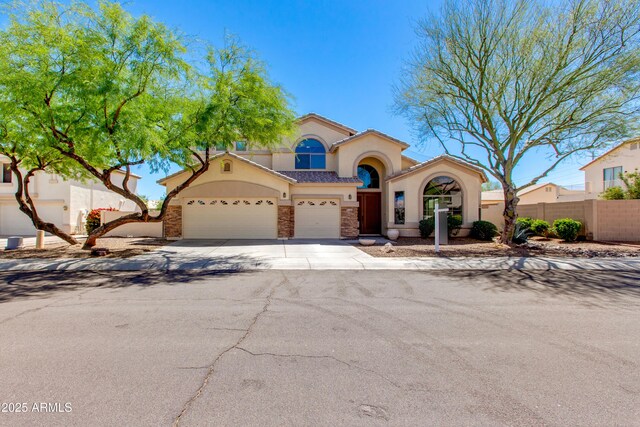 7421 S 25th Ln, Phoenix, AZ 85041 - mediterranean / spanish-style home featuring fence, stucco siding, an attached garage, and concrete driveway
