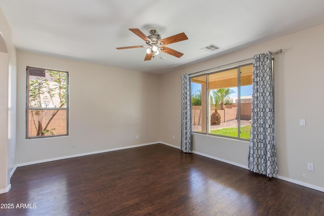 7421 S 25th Ln, Phoenix, AZ 85041 - spare room featuring healthy amount of natural light, wood finished floors, ceiling fan, and baseboards