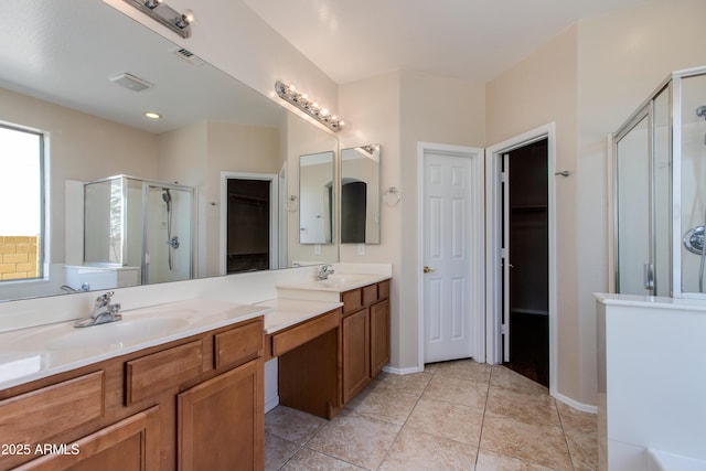 7421 S 25th Ln, Phoenix, AZ 85041 - full bath featuring a shower stall, a walk in closet, double vanity, and tile patterned flooring