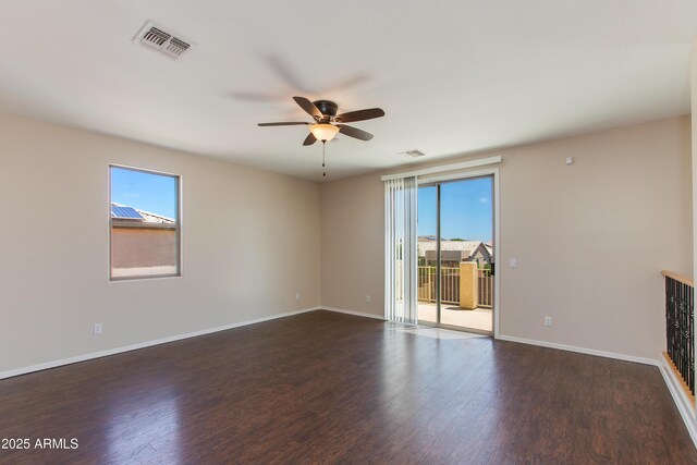 7421 S 25th Ln, Phoenix, AZ 85041 - empty room with plenty of natural light, a ceiling fan, wood finished floors, and baseboards