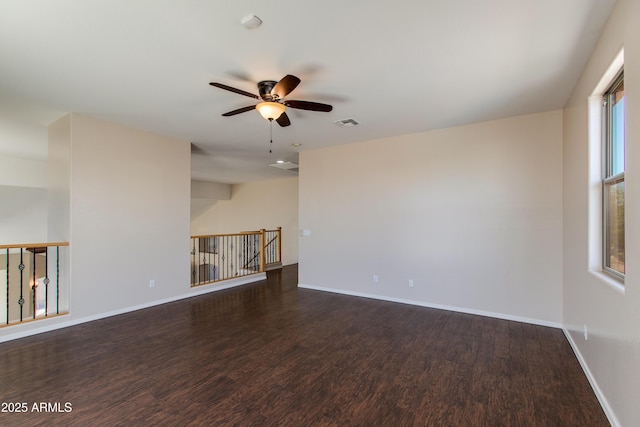 7421 S 25th Ln, Phoenix, AZ 85041 - unfurnished living room featuring ceiling fan, wood finished floors, and baseboards