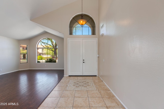 7421 S 25th Ln, Phoenix, AZ 85041 - entryway featuring vaulted ceiling, wood finished floors, and baseboards