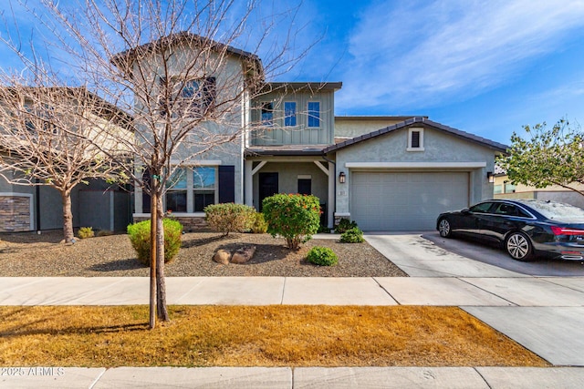 traditional home with concrete driveway, an attached garage, and stucco siding