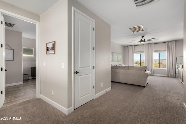 interior space with carpet floors, visible vents, and baseboards