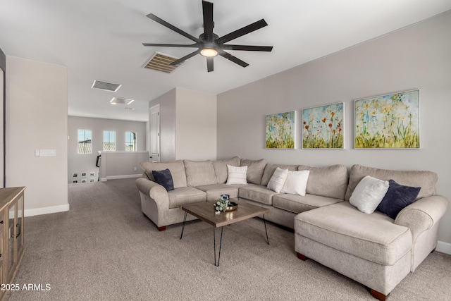 living area featuring baseboards, visible vents, ceiling fan, and carpet flooring